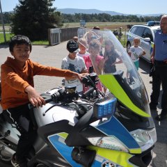 Kind sitzt auf einem Polizei-Motorrad